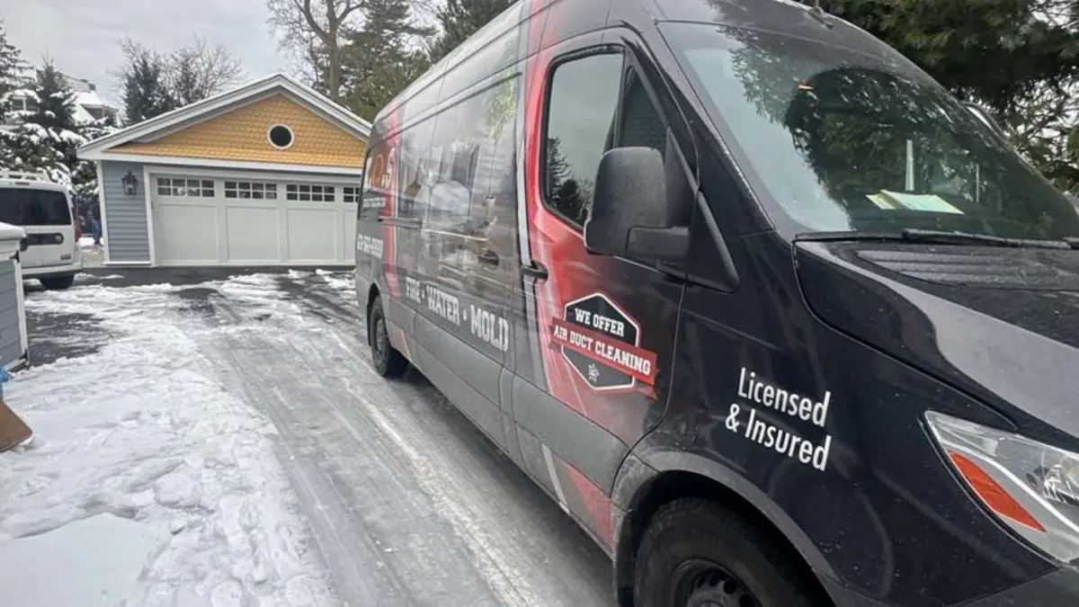 K.O.S. van outside a Centerport home in winter for a basement moisture job