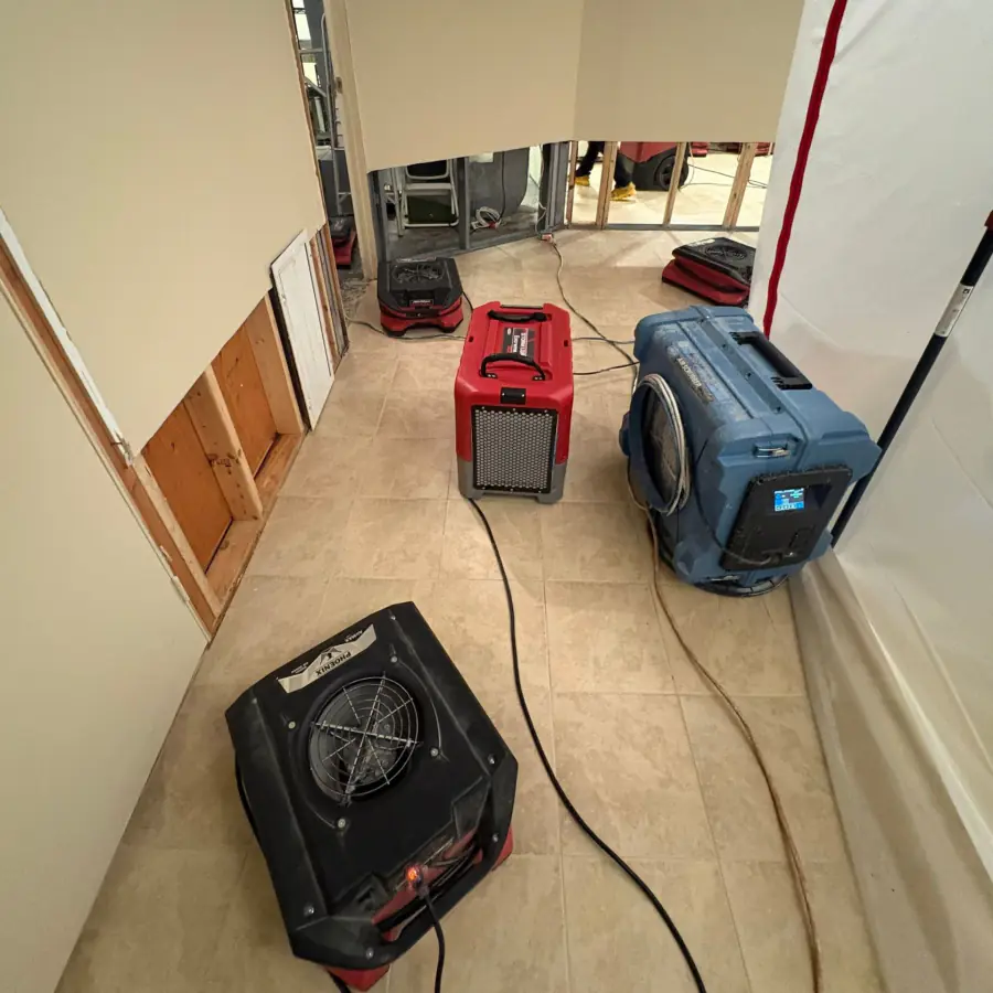 Air movers and LGR dehumidifier drying the basement hallway