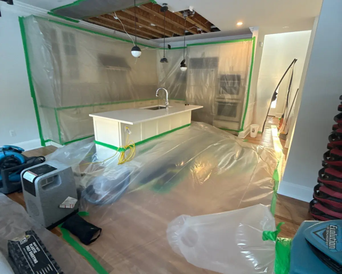 Kitchen in Quogue under containment with hardwood drying mats on the floor