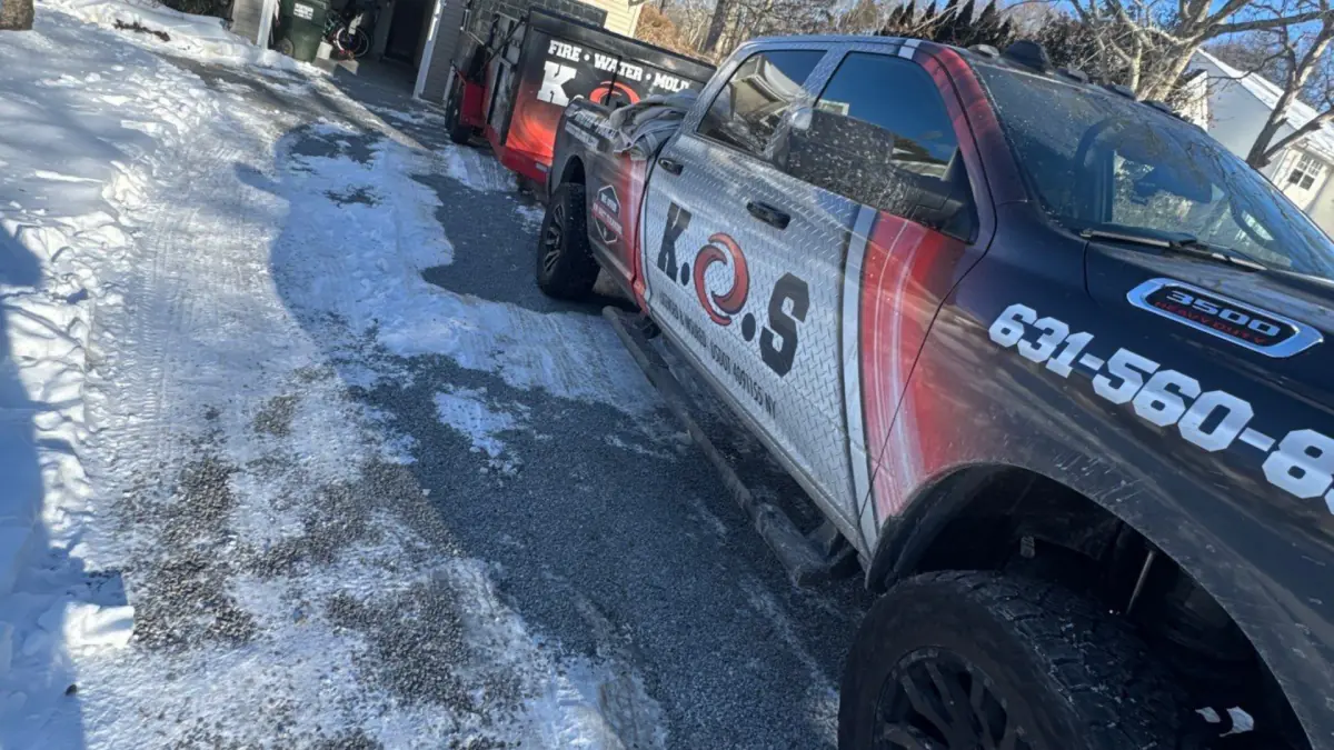 K.O.S. pickup outside a Westhampton home with basement mold after a water heater leak
