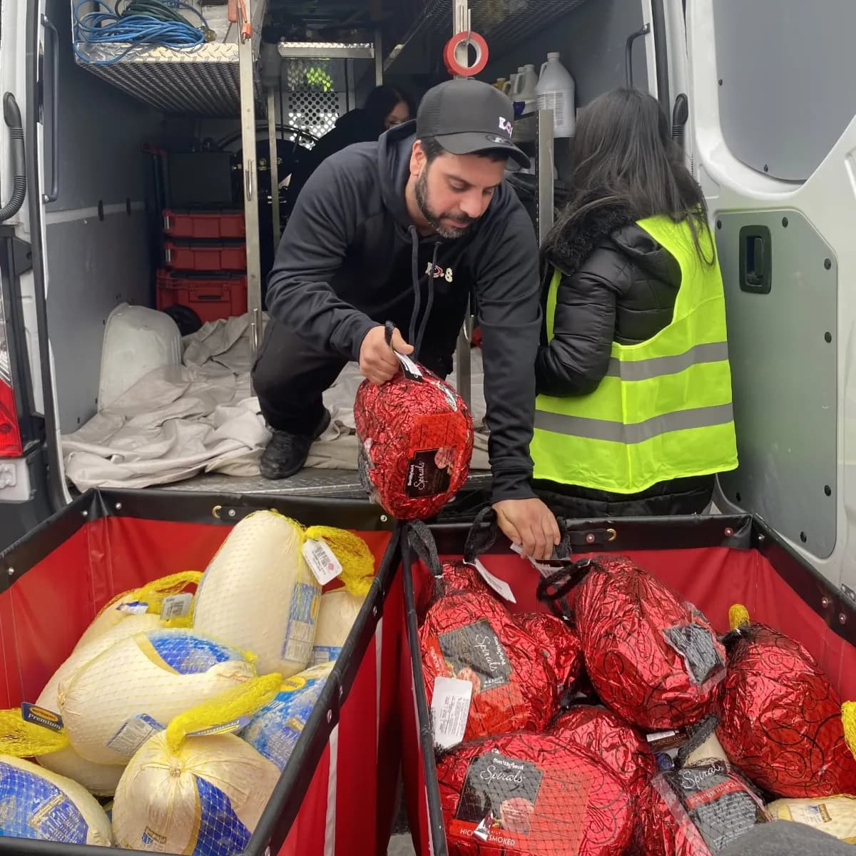 K.O.S. Restoration crew unloading hams from the van into collection bins