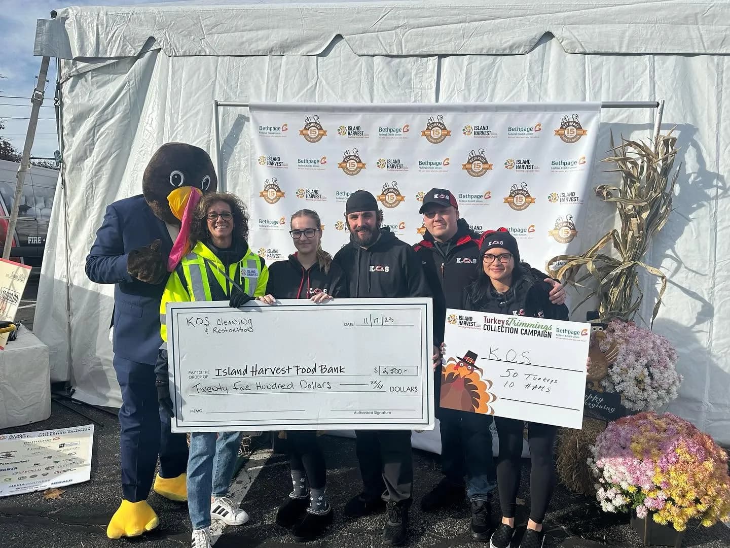 K.O.S. Restoration team presenting a $2,500 check to Island Harvest Food Bank