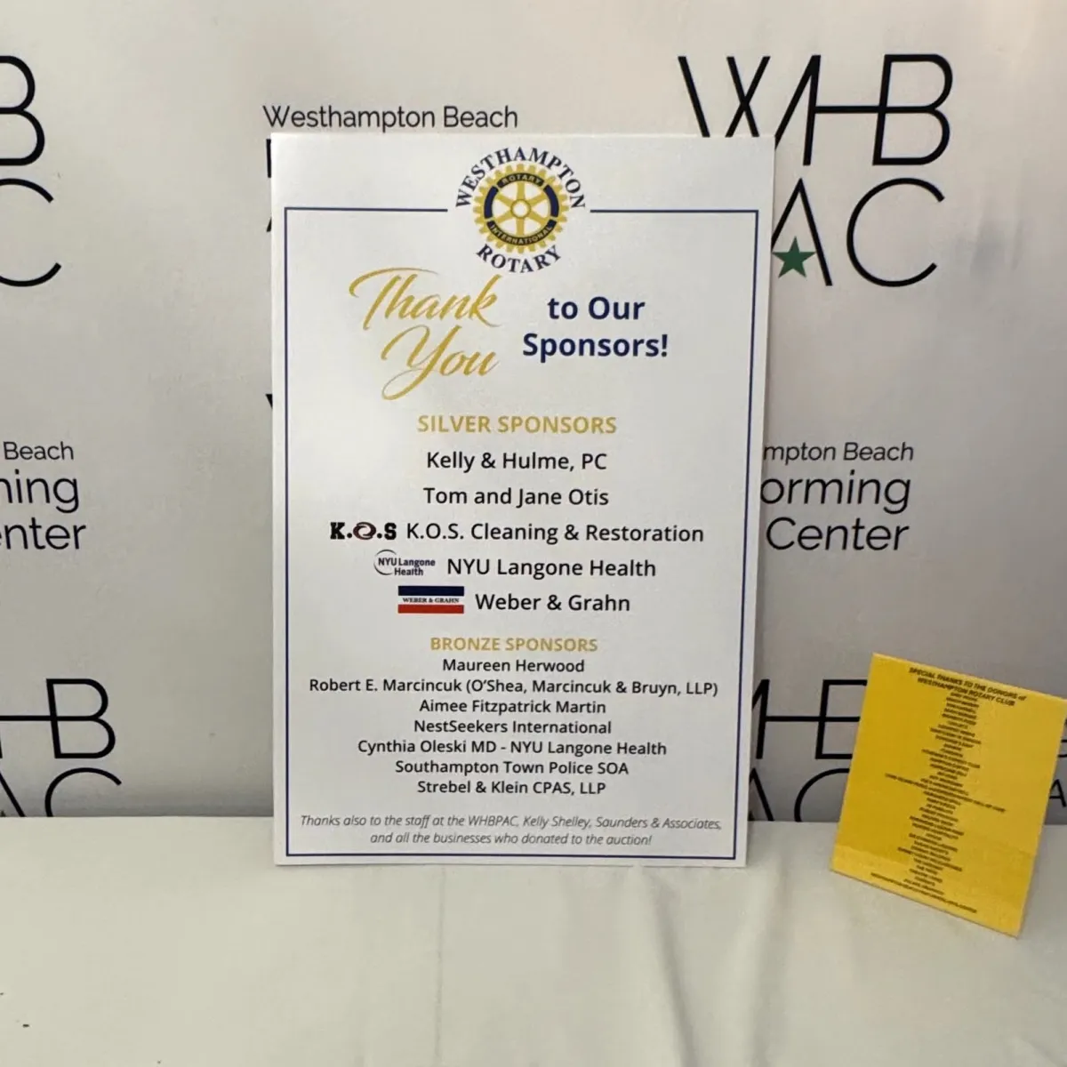 Westhampton Beach Rotary sponsor board listing K.O.S. Restoration as a Silver Sponsor