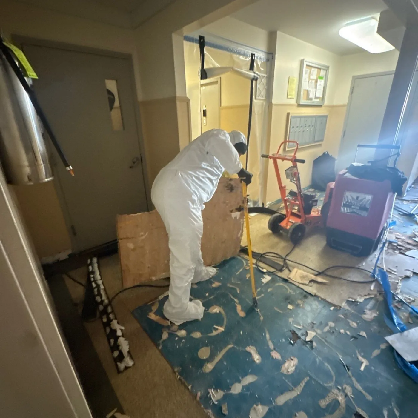 Dehumidifier and air mover drying a gutted bathroom after a pipe leak in Huntington Station
