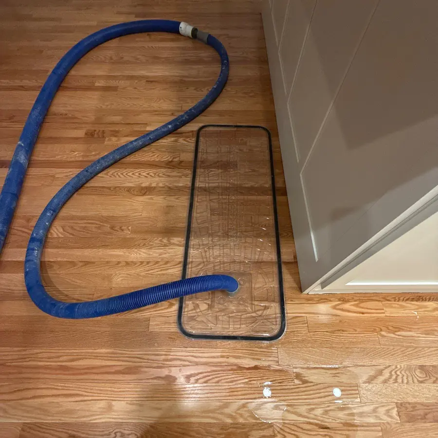 Floor-mat drying system pulling moisture out of hardwood in Quogue