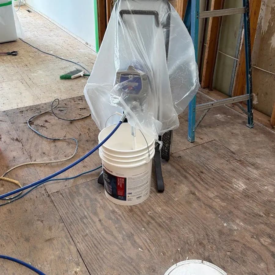 Professional mold-resistant coating and airless sprayer set up on site