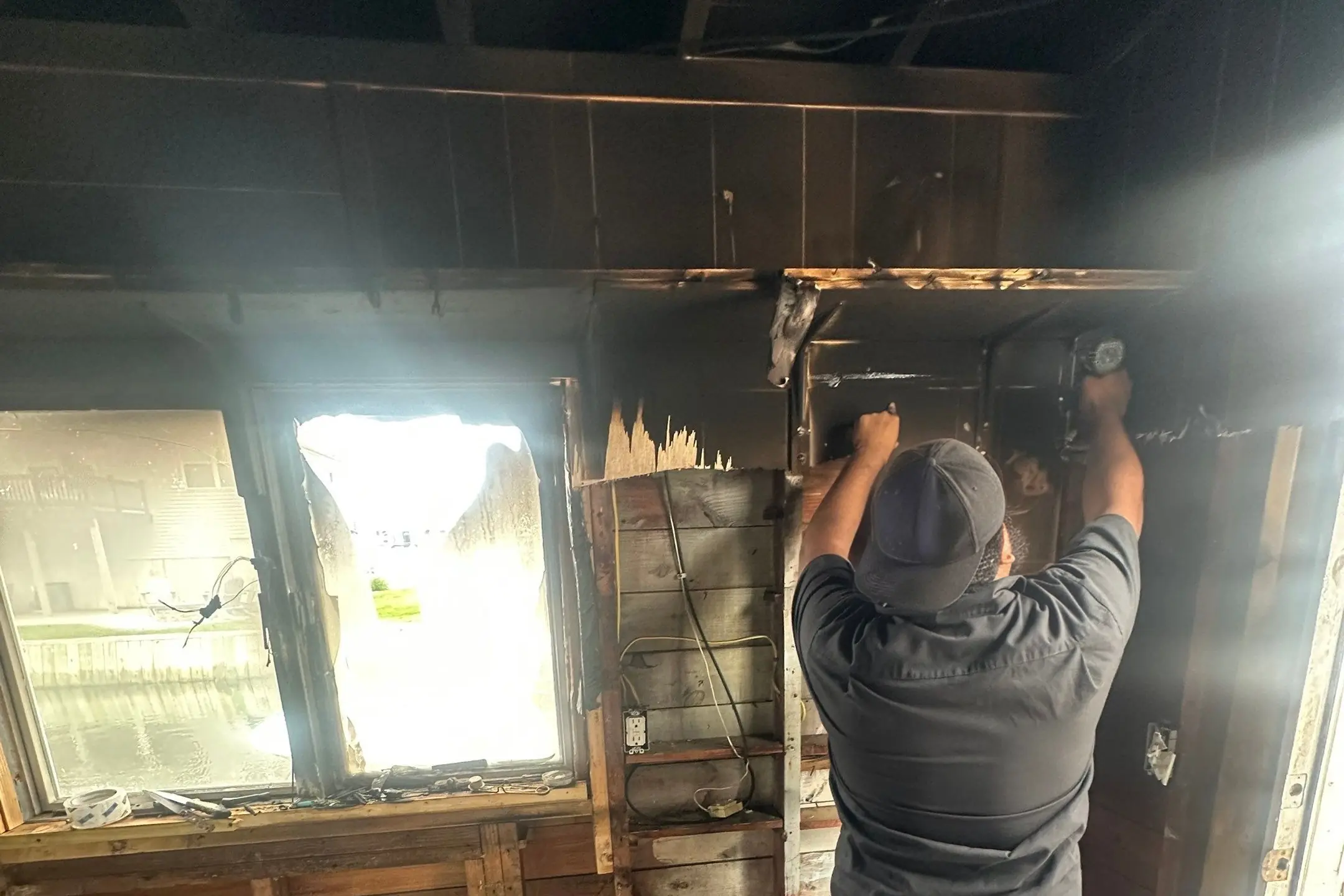 K.O.S. technicians tearing out fire-charred walls and packing out smoke-damaged contents