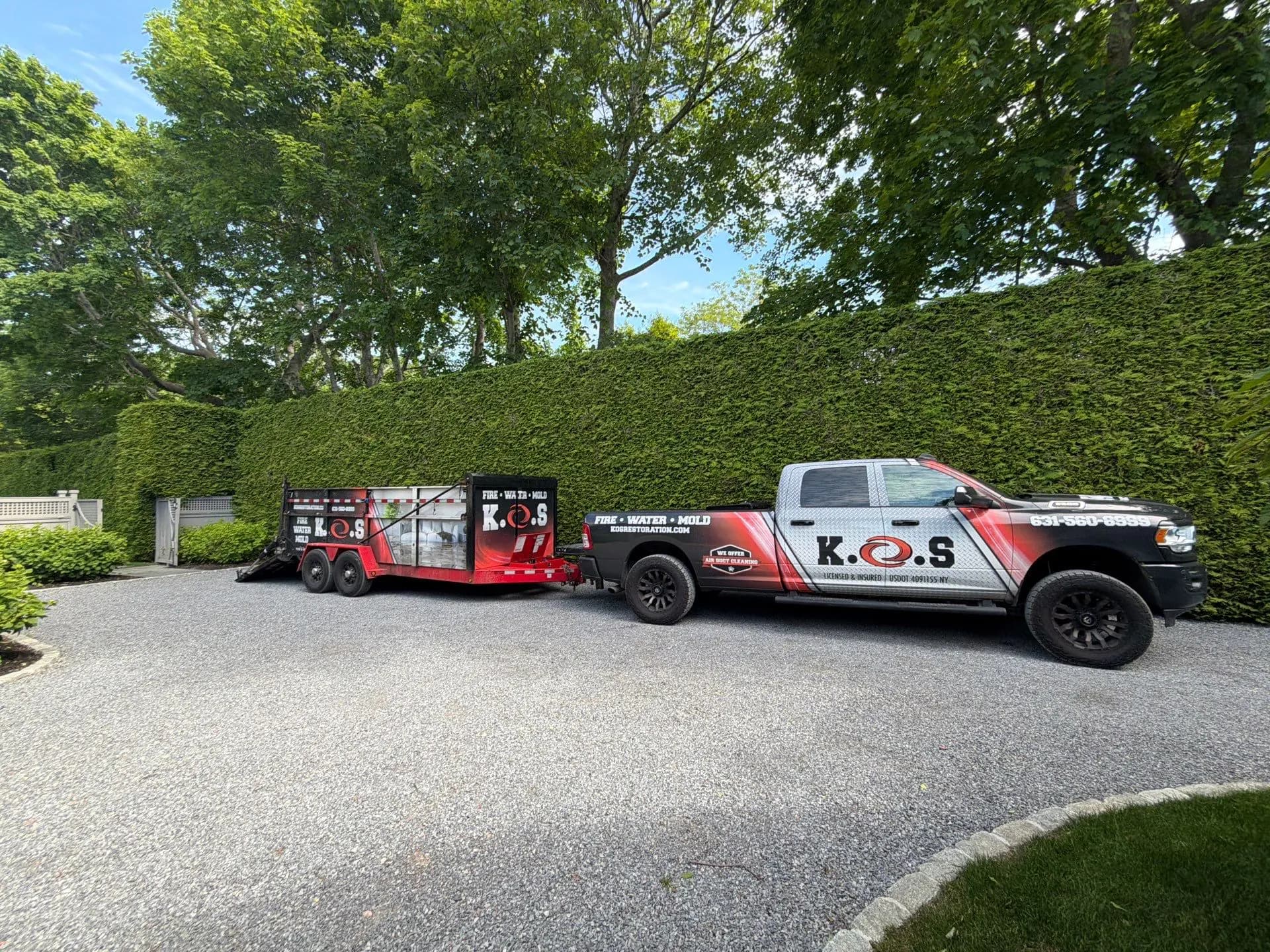 K.O.S. Restoration trucks on-site at a Long Island home