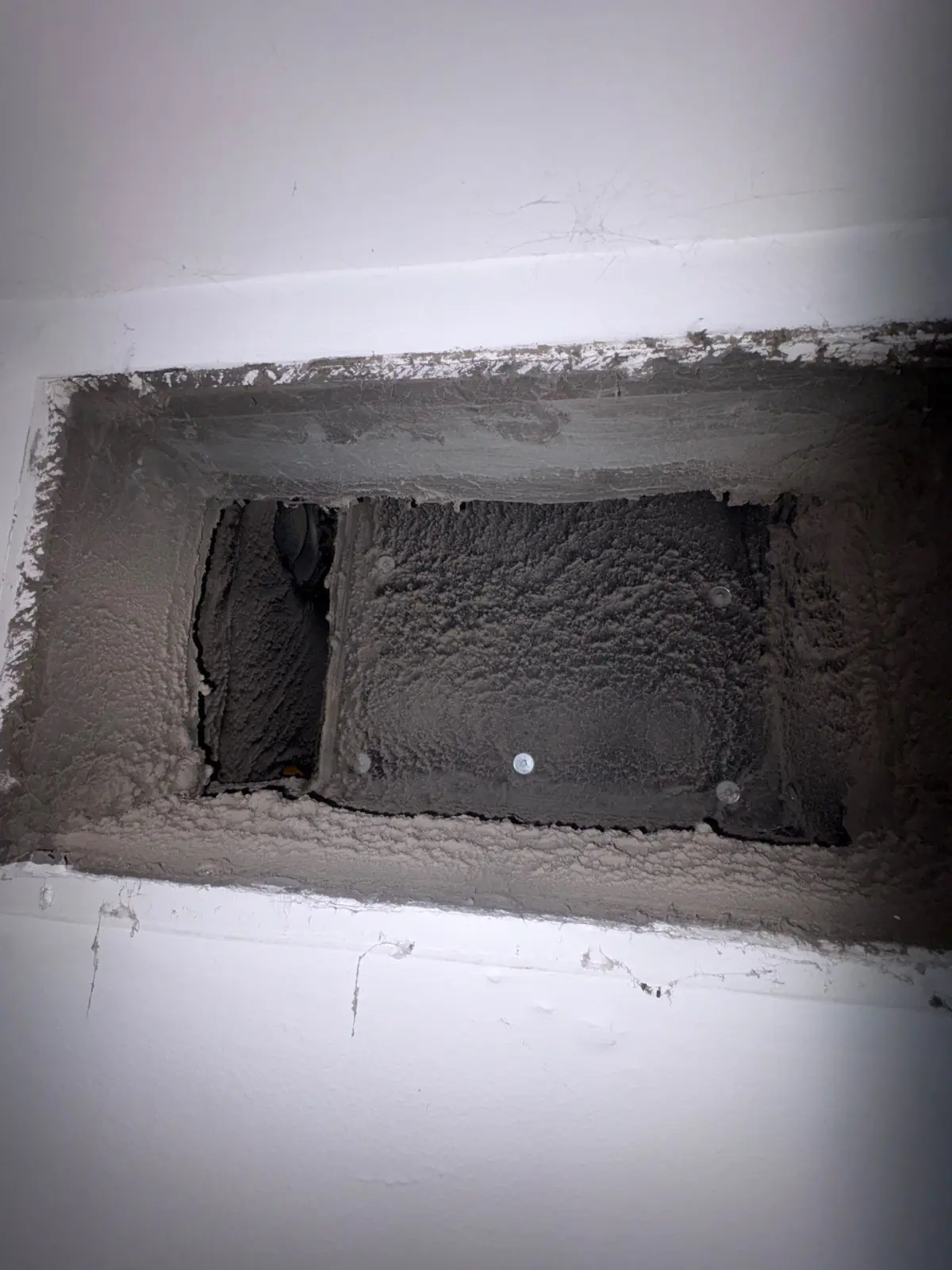 Supply register opening lined with years of dust before air duct cleaning, East Patchogue