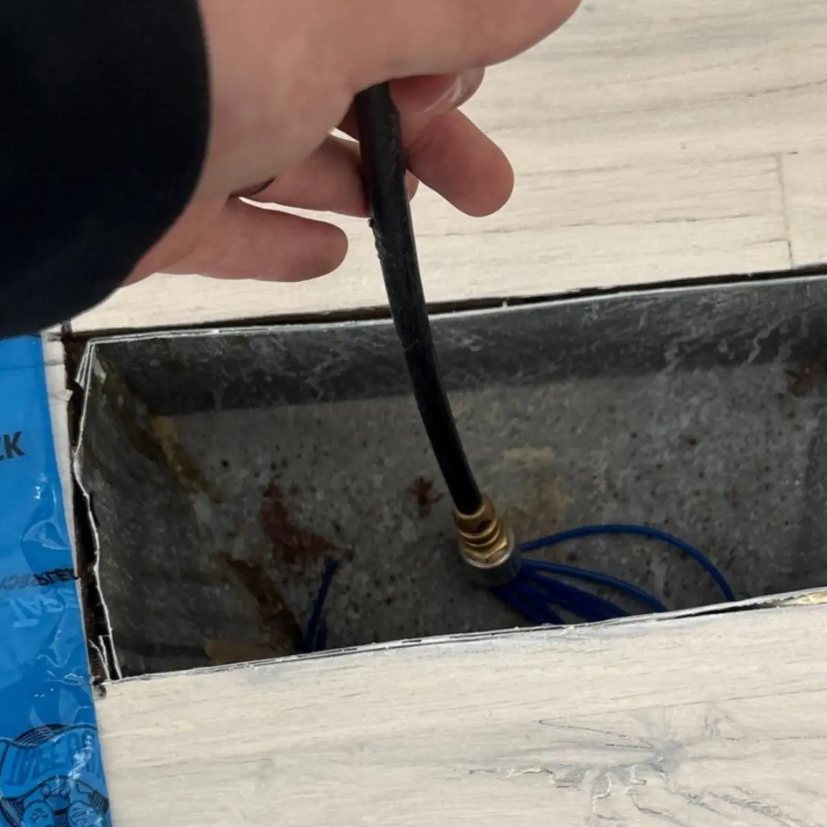 Compressed-air tool working inside a supply line at a Westhampton Beach home