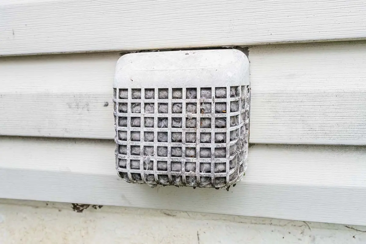 Outside dryer vent hood packed with lint