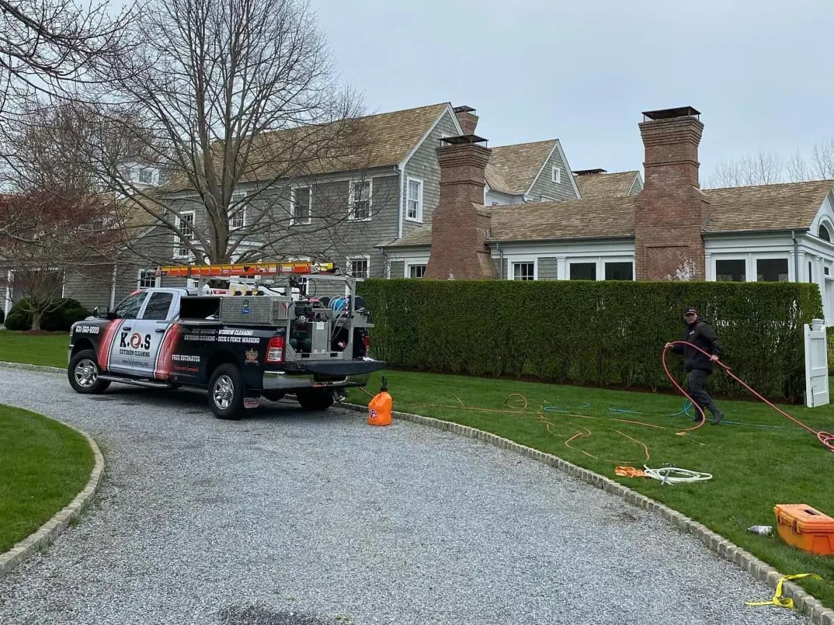 K.O.S. soft-wash truck and technician at a shingle home on Long Island