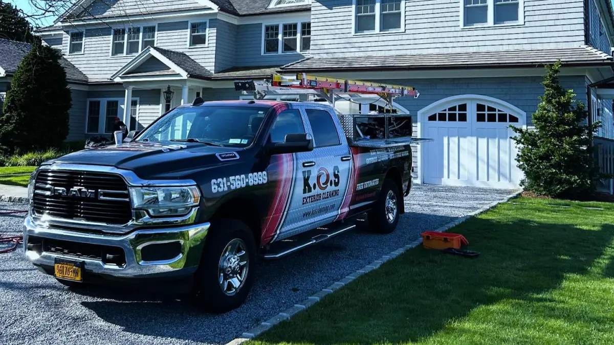 Technician power washing a patio to prep a Suffolk County home for summer
