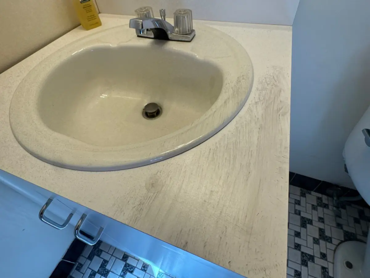 Bathroom sink and vanity coated in soot residue