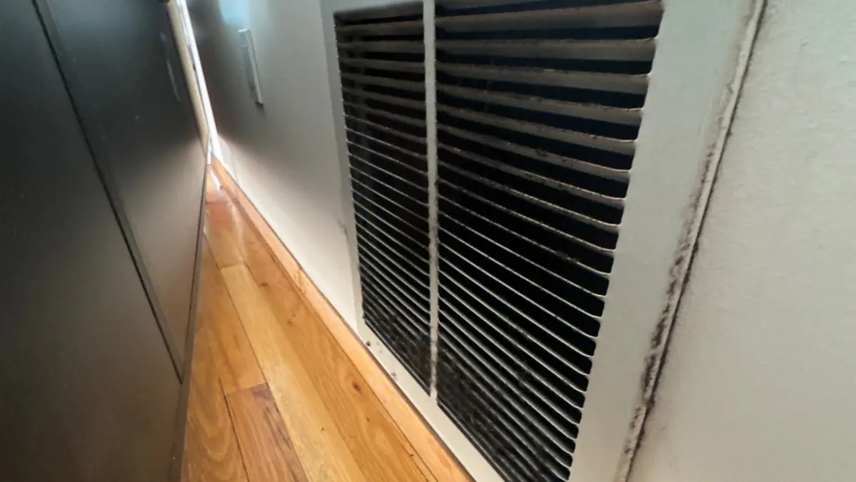 IICRC-certified technician performing soot cleanup after fire damage in a Long Island home