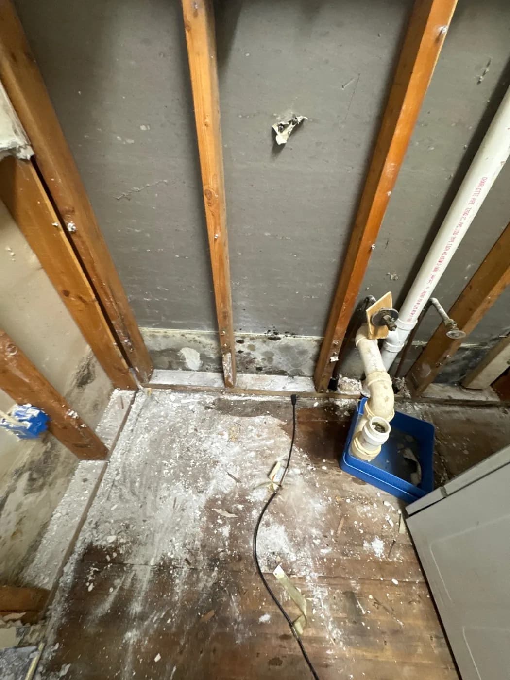 Laundry area opened to framing and subfloor during water damage restoration in Greenlawn NY
