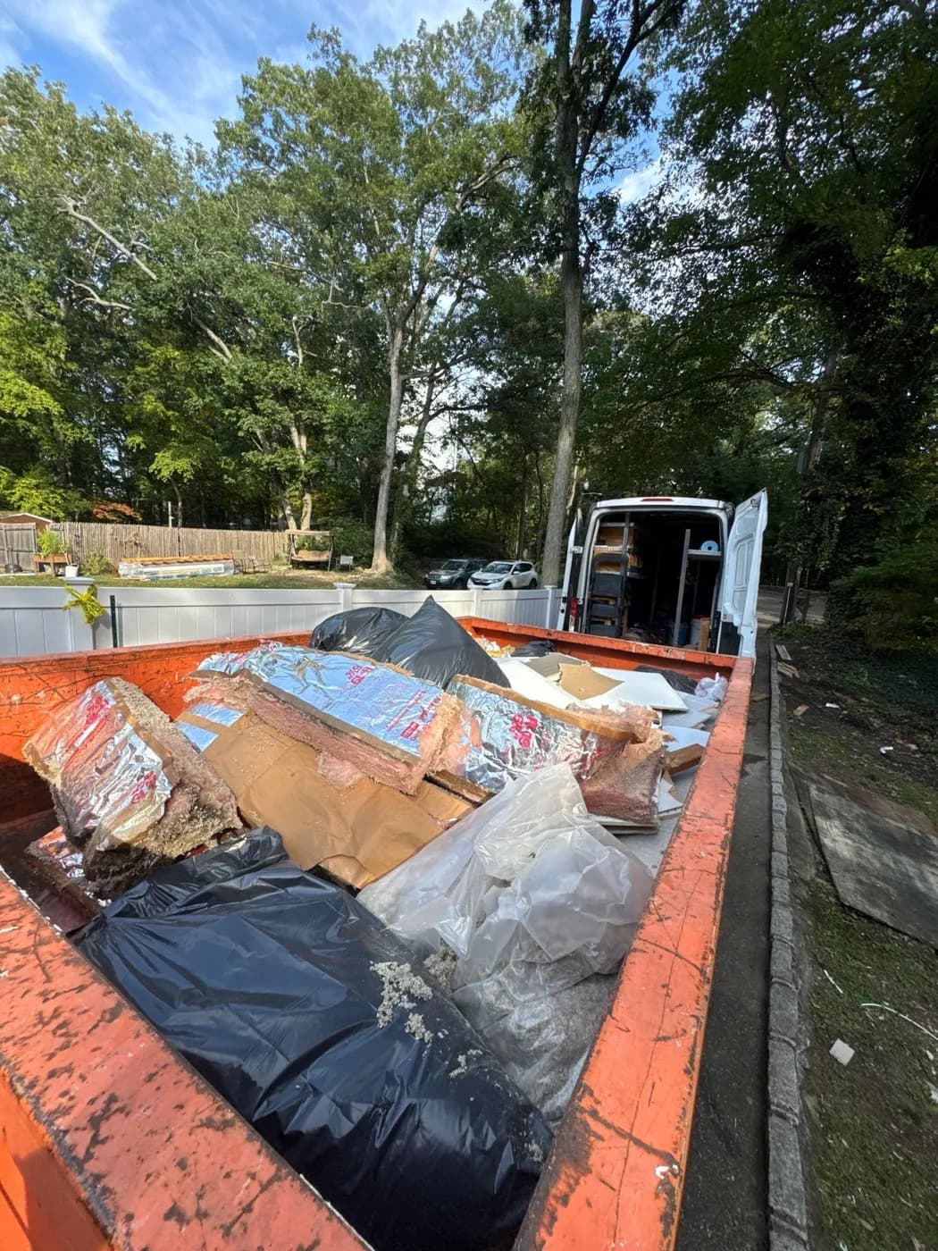 Dumpster filled with water-damaged materials removed from a Greenlawn NY home