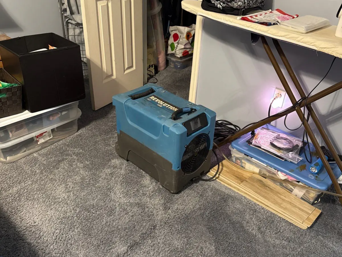Dehumidifier running in the bedroom during drying