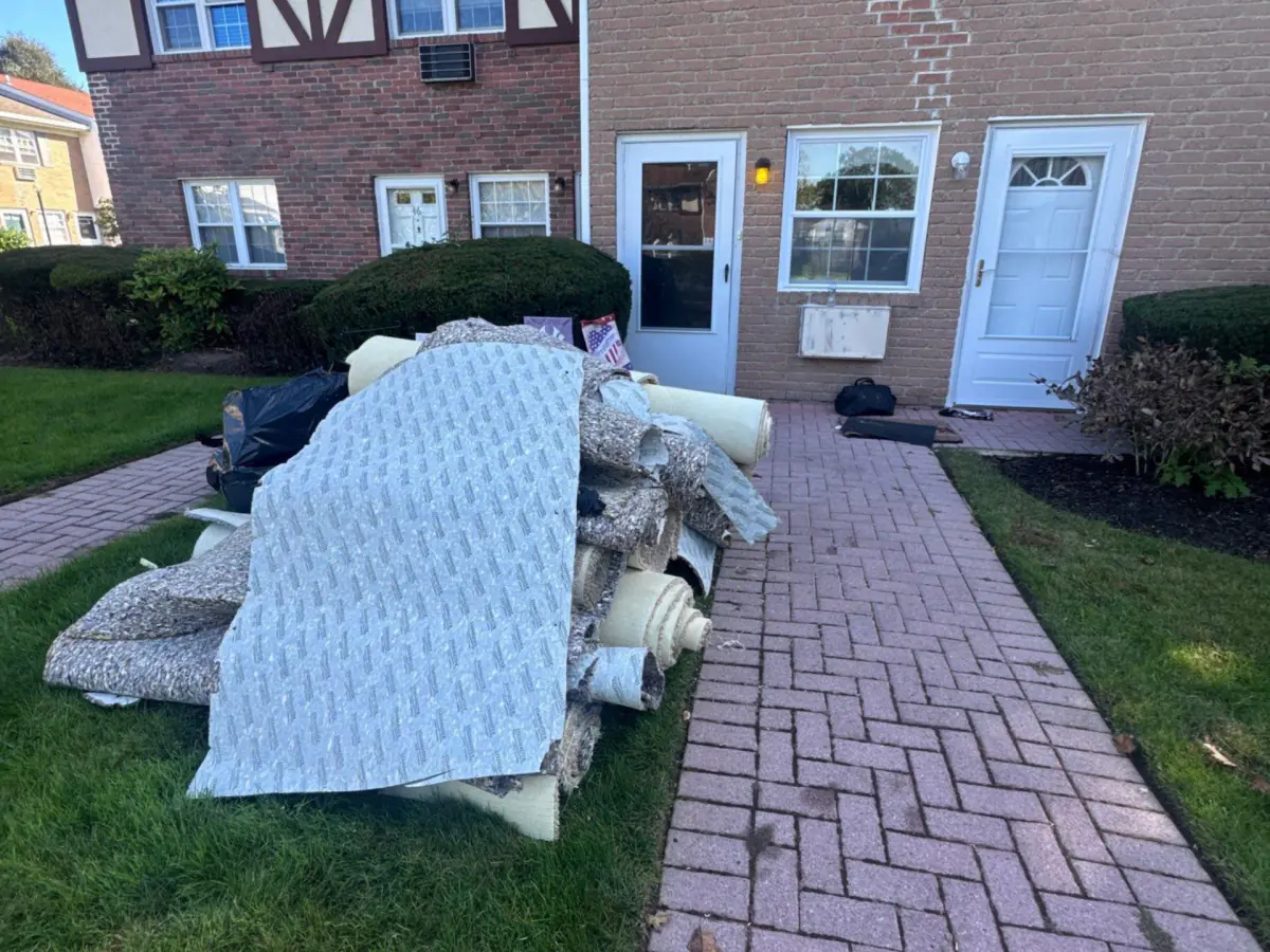 Wet carpet and padding removed and piled outside the condo