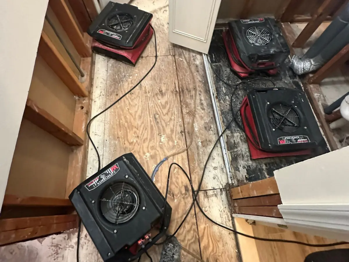 Air movers drying the subfloor along the closet