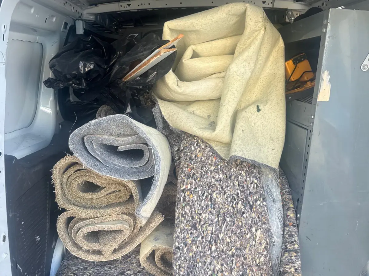 Removed carpet and padding loaded into the K.O.S. van for disposal