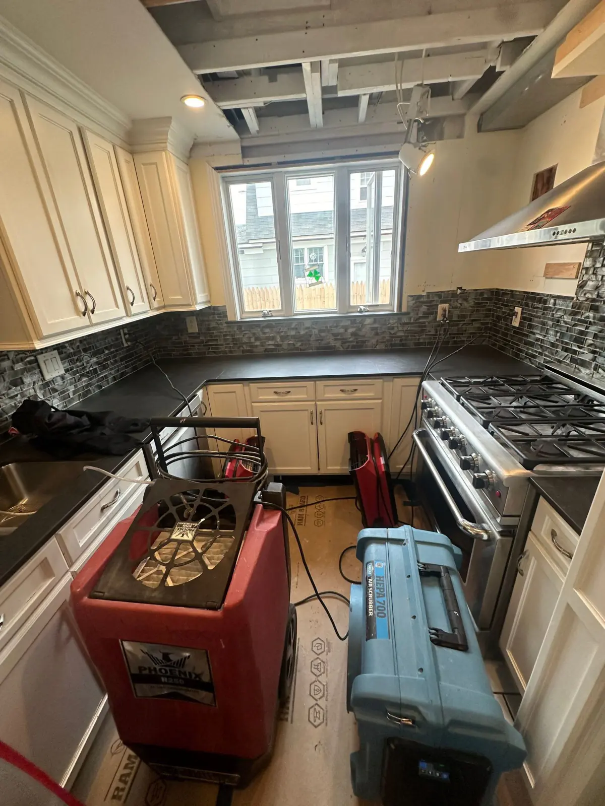 Dehumidifiers drying the kitchen after mold remediation