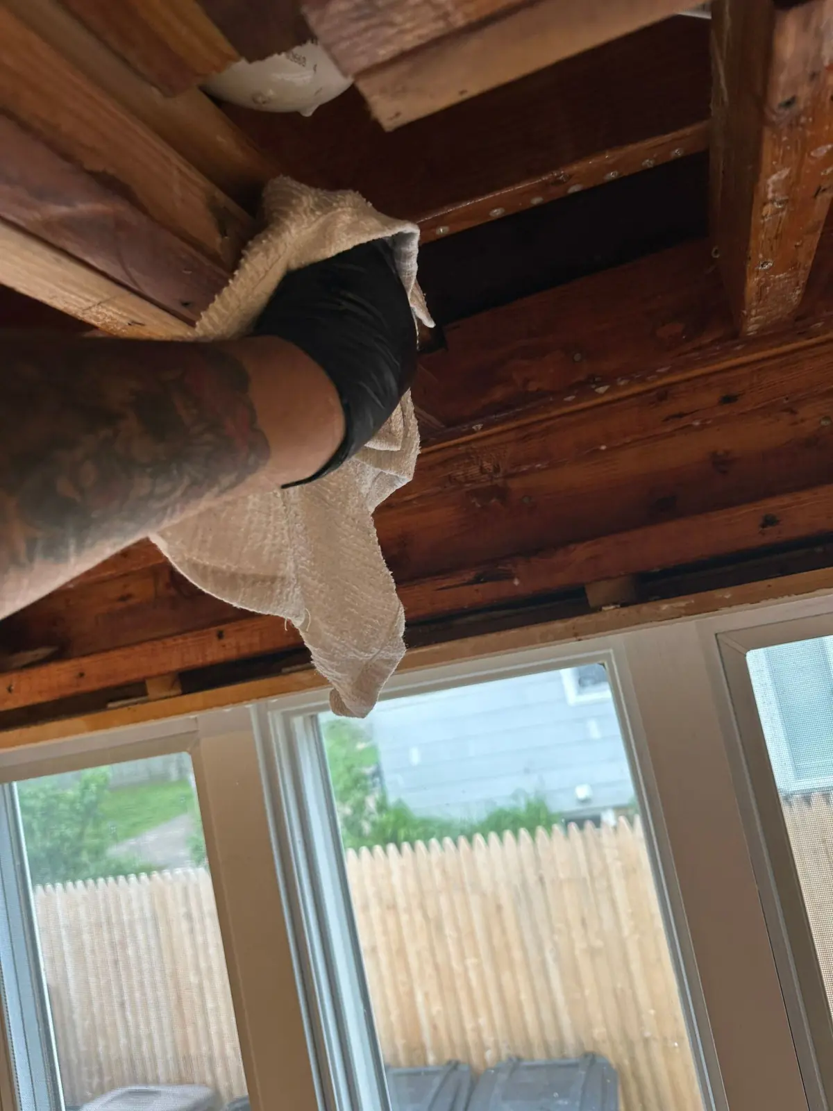 Wiping down ceiling joists by hand