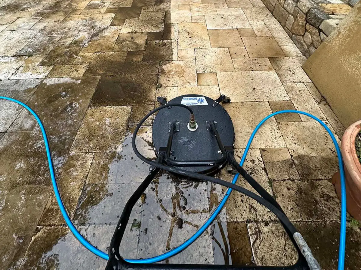 Surface cleaner working across a travertine patio
