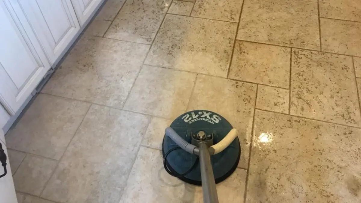 Rotary surface cleaner on a tile floor, half cleaned