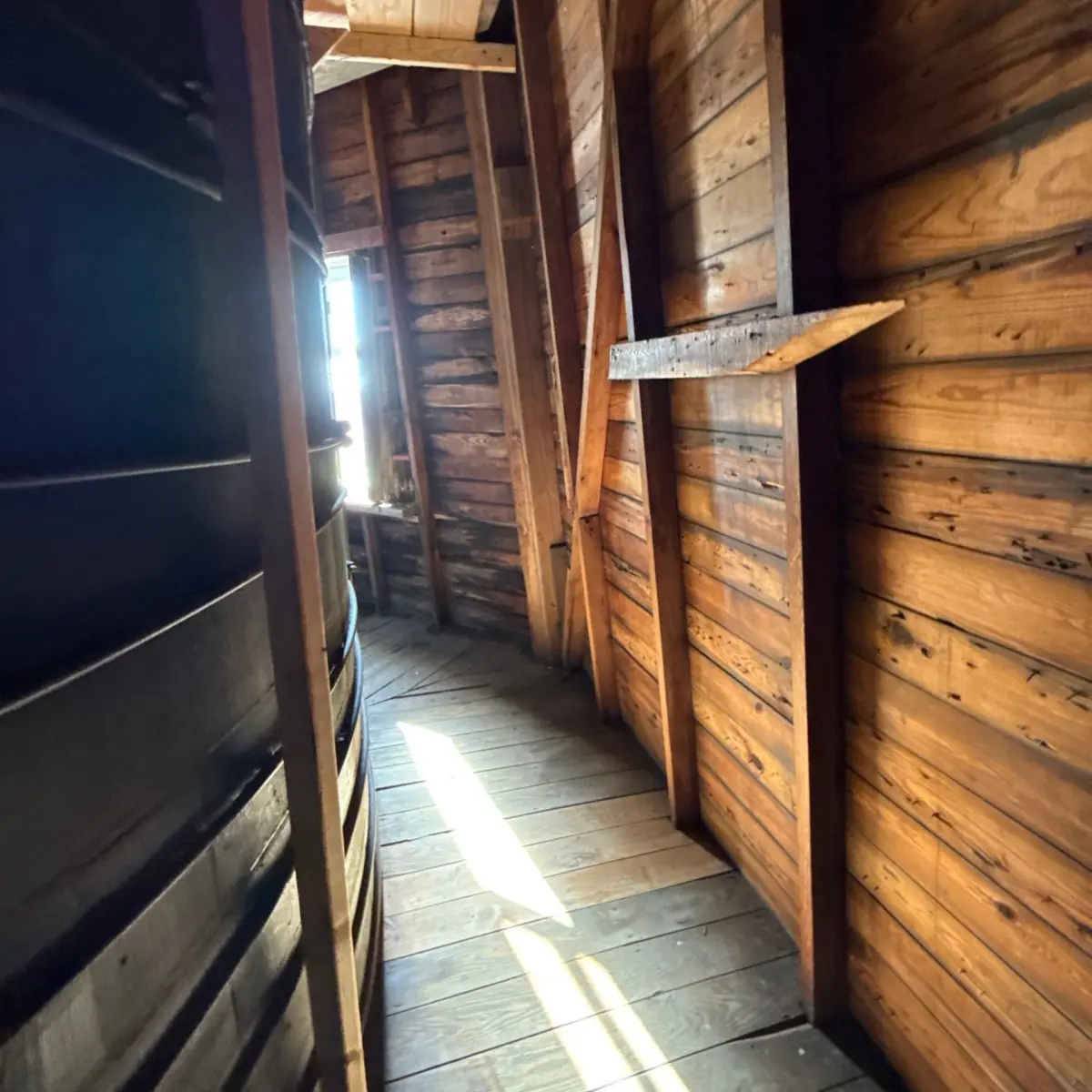 Clean floorboards and walls along the windmill's inner passage