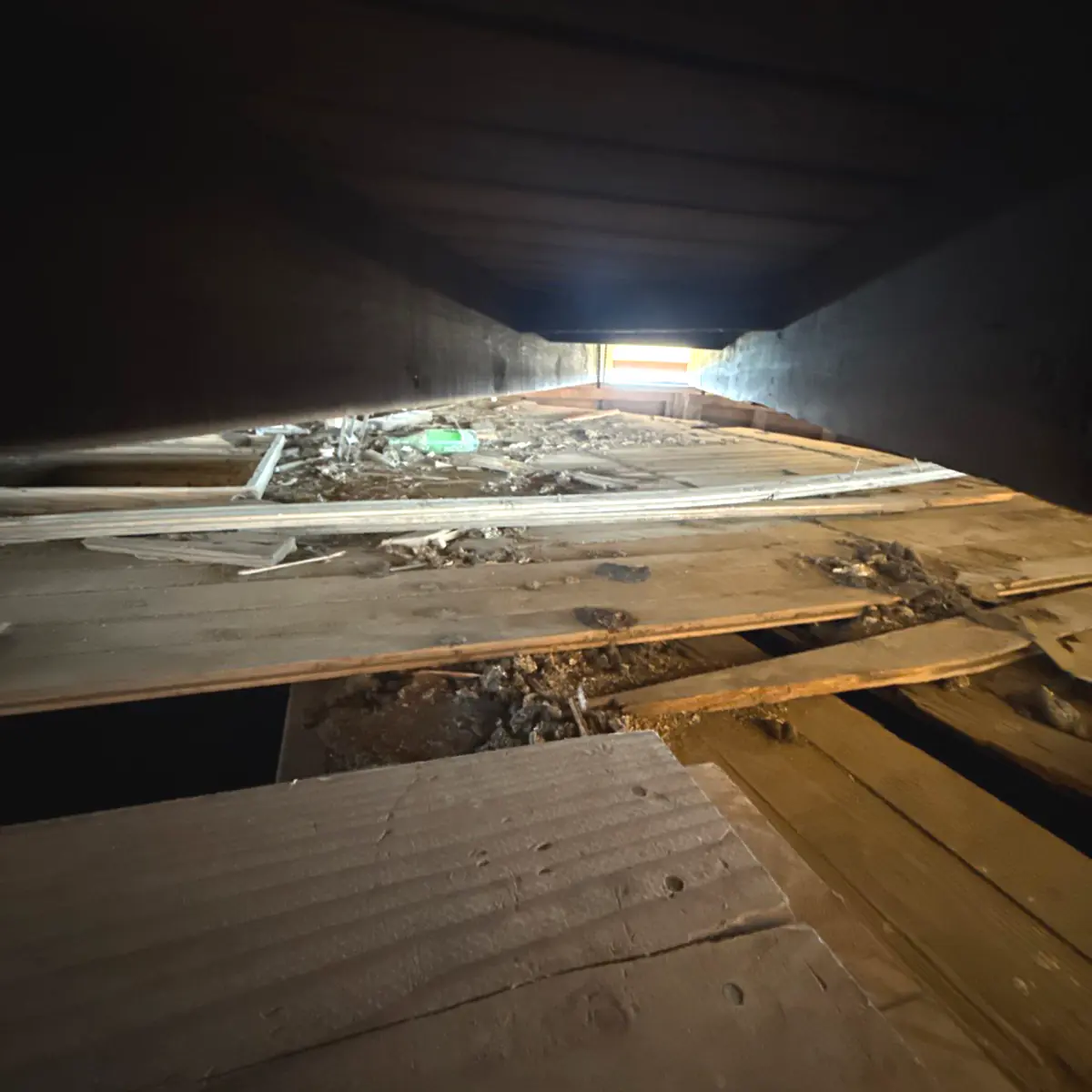 Debris-covered floorboards on the windmill's upper level