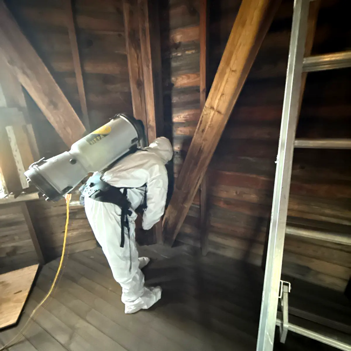 Technician HEPA-vacuuming the windmill's interior walls