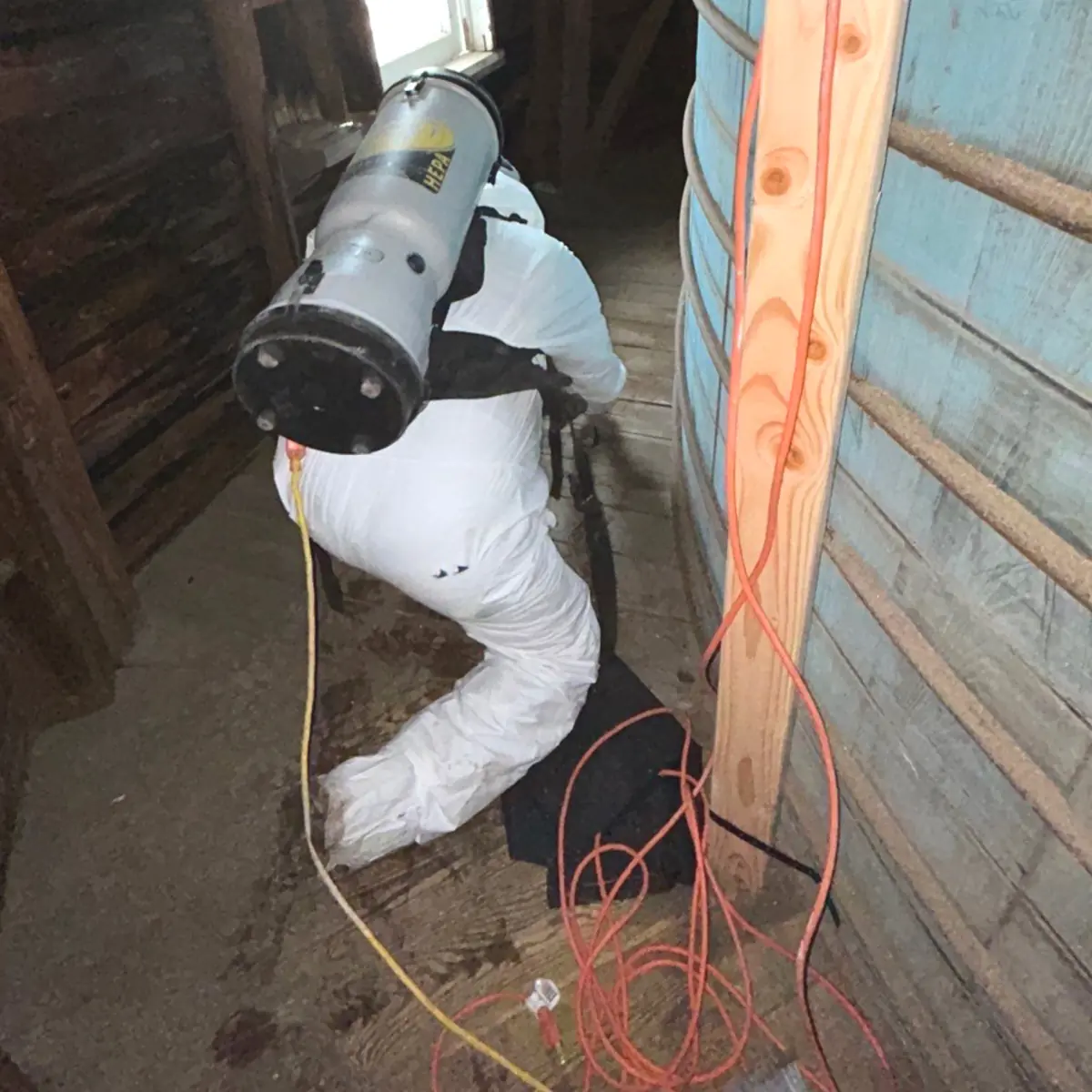 Technician HEPA-vacuuming along the windmill's curved inner wall