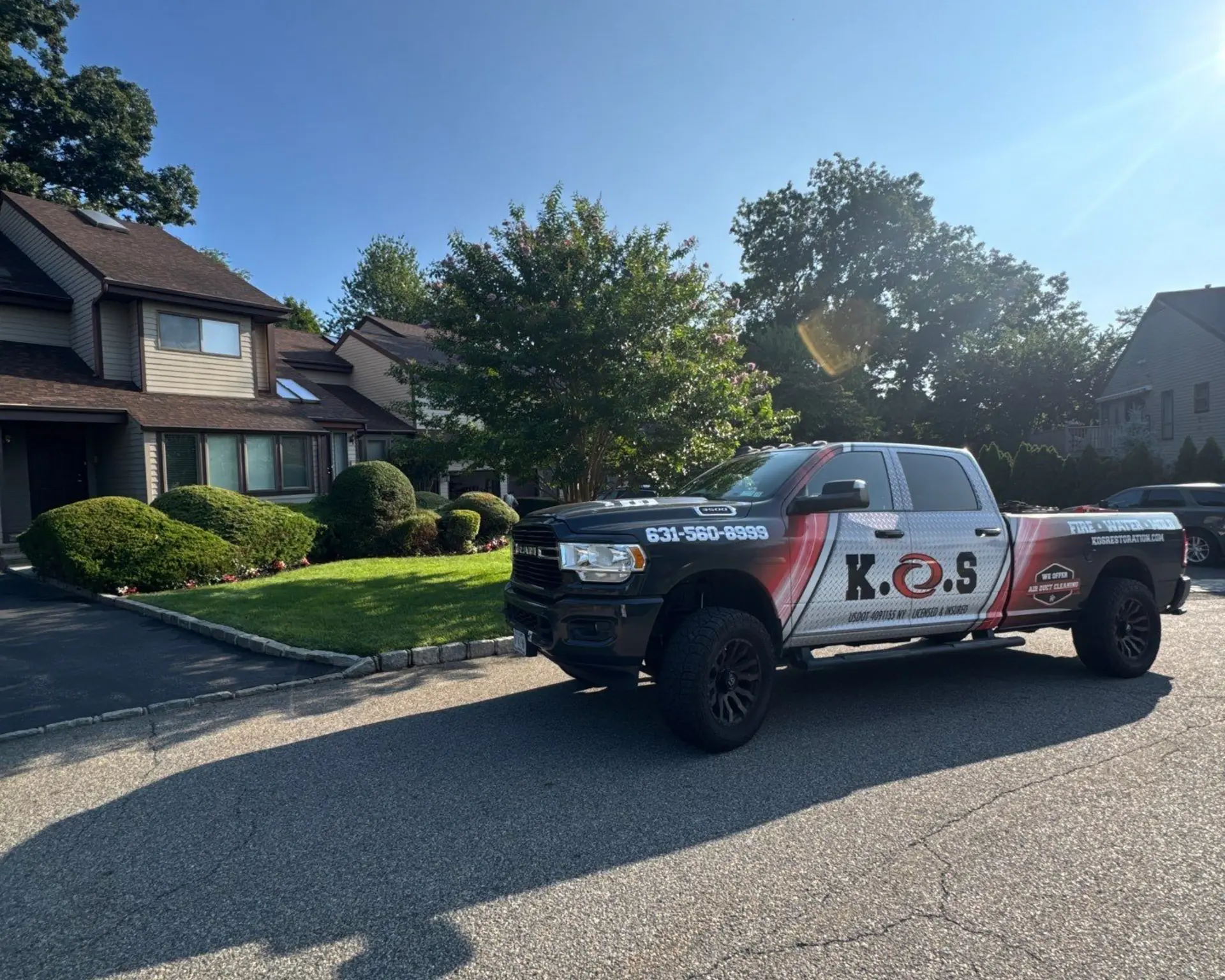 K.O.S. Restoration pickup parked in the driveway of a Suffolk County home
