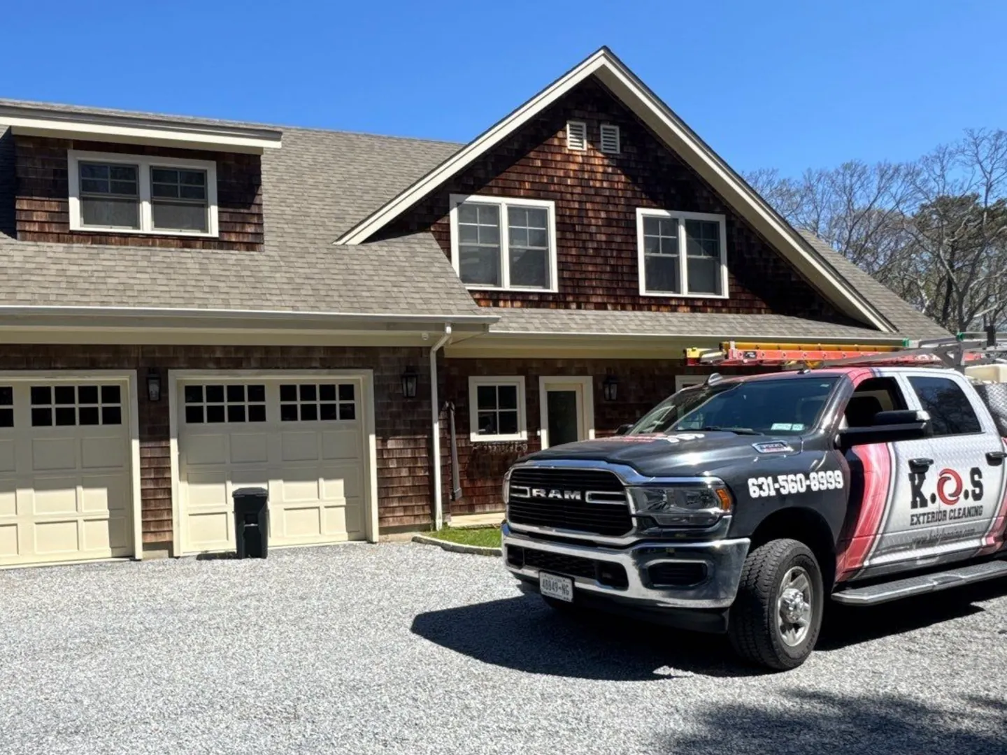 K.O.S. exterior cleaning pickup in the driveway of a cedar-shingle Long Island home